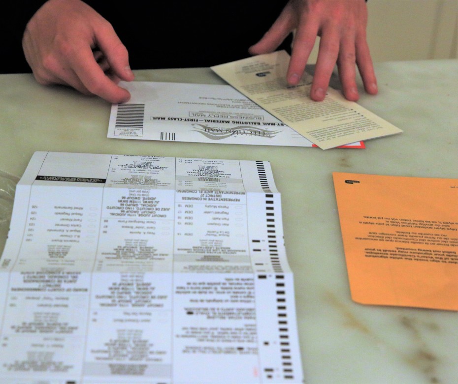 Person filling out mail-in ballot