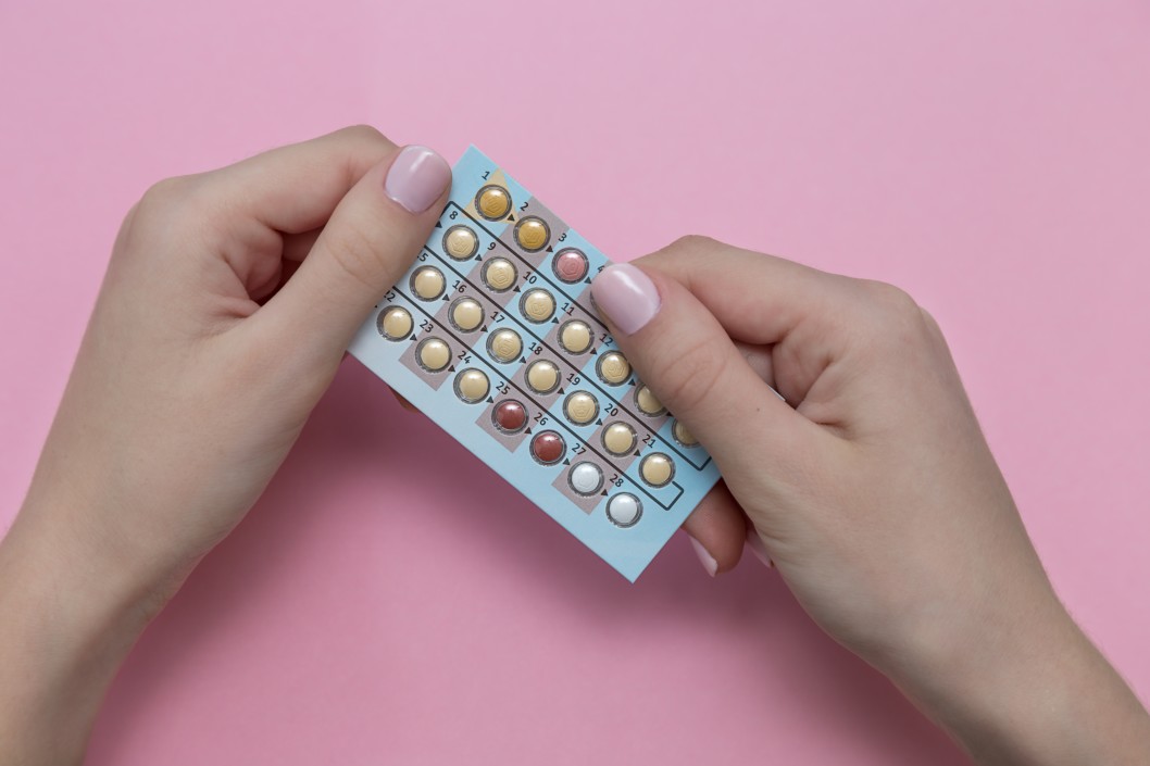 Person holding birth control pack
