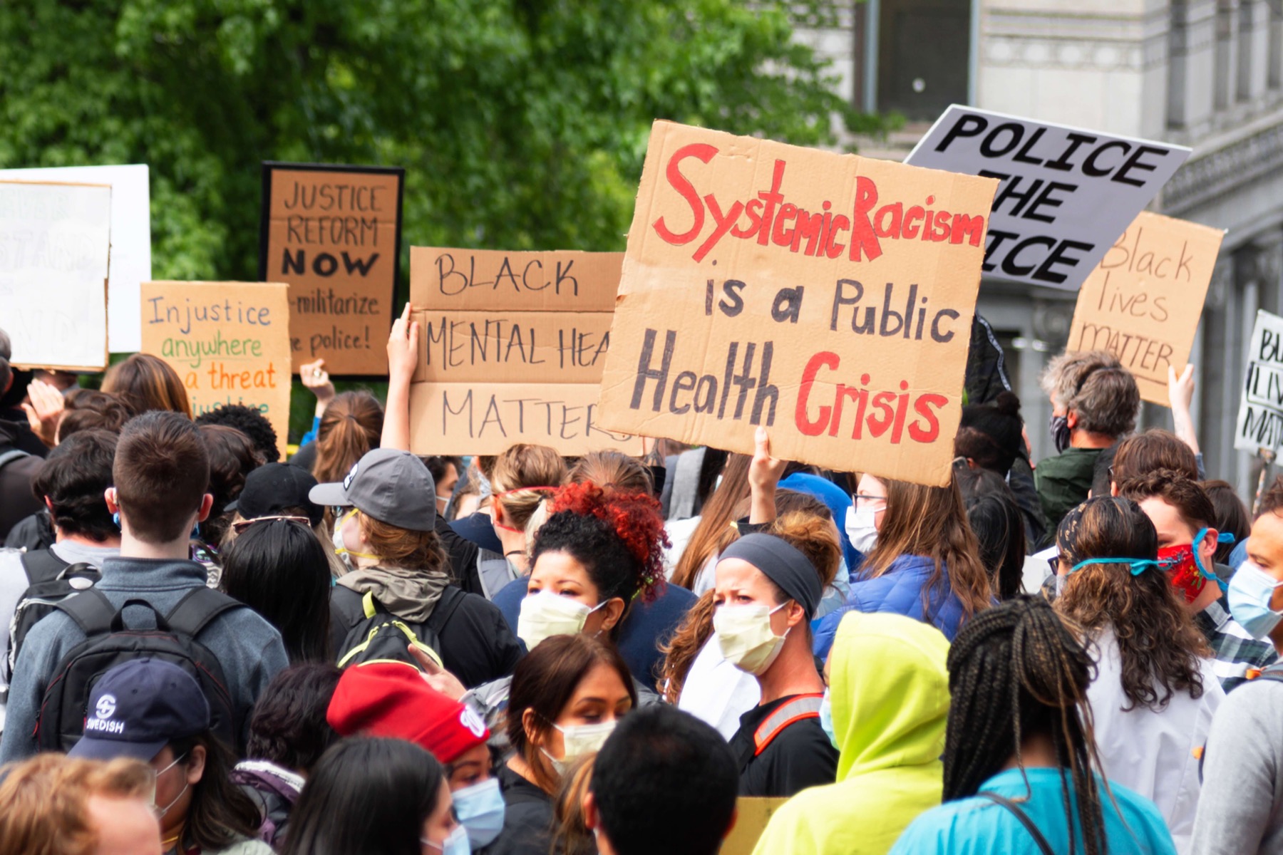 Protestors wearing protective masks march in a street for Black Lives Matter