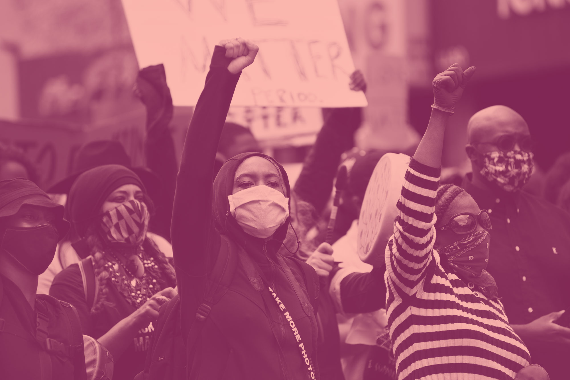 Black women with raised fists at protest