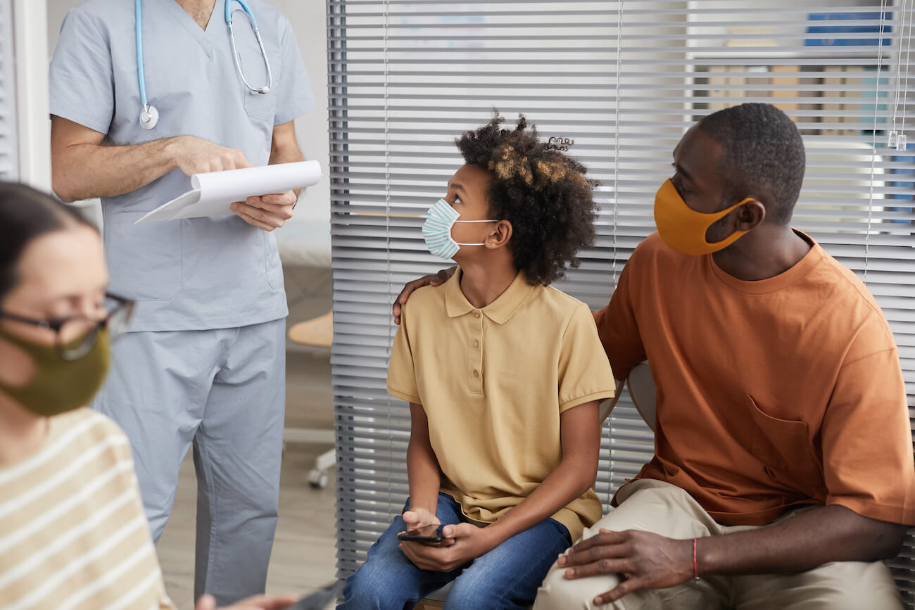 father and son waiting in line at hospital