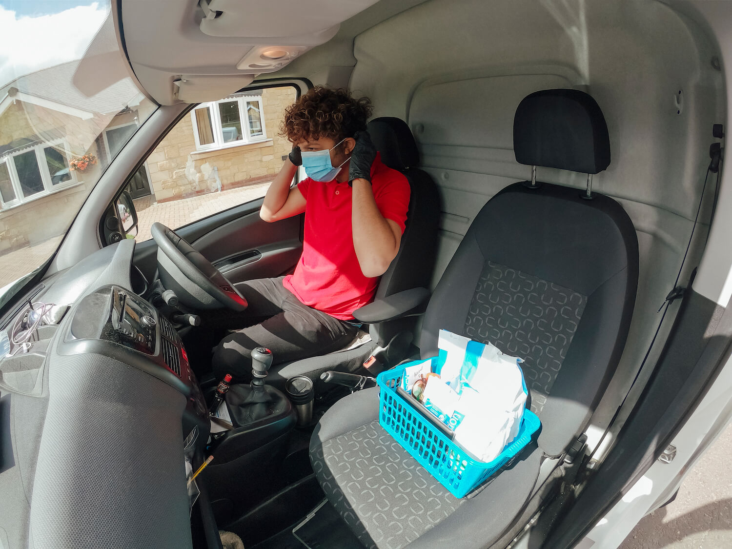 Masked worker in truck prepares for shift
